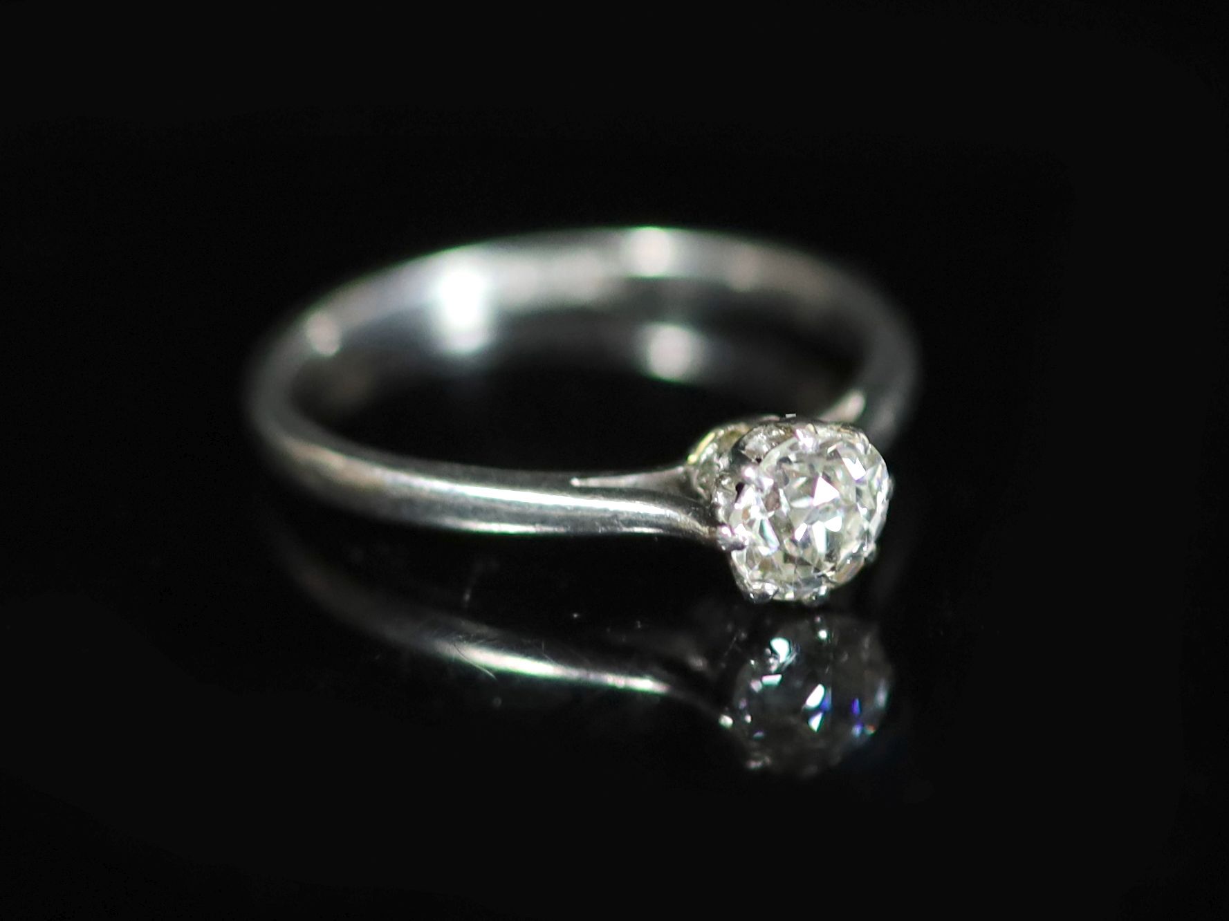 A platinum and diamond solitaire ring, the claw-set circular brilliant cut diamond approximately 0.5ct